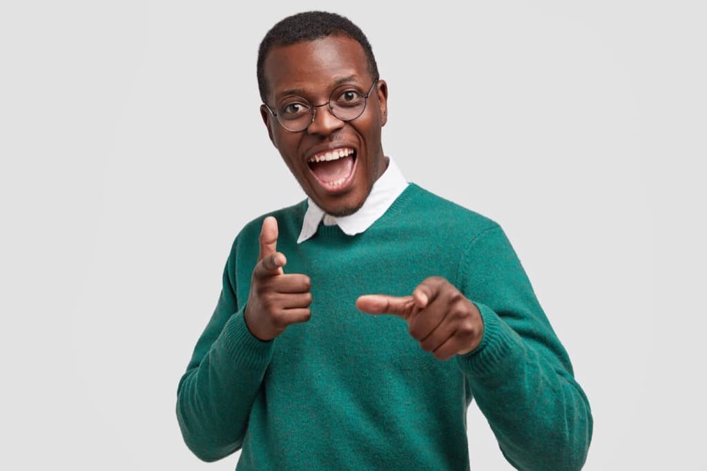 Man pointing and smiling at mental health day org
